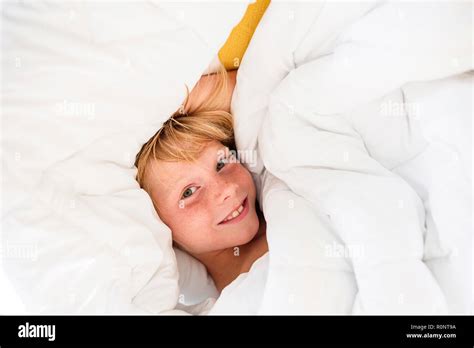 Overhead View Of A Smiling Boy Lying In Bed Stock Photo Alamy