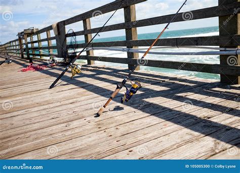 Fishing Rods On A Wooden Marine Jetty Or Pier Stock Photo Image Of