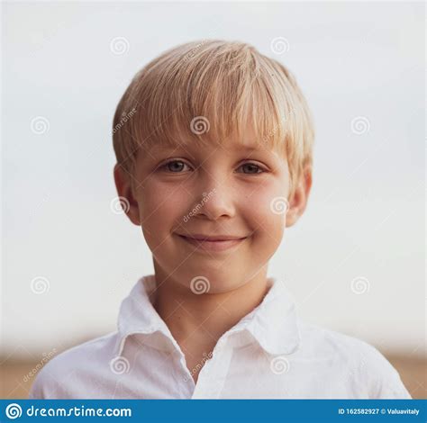 Face Close Up Of A Boy Of Eight Years Portrait Of A Smiling Boy In