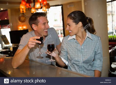Young Couple Laughing Drinking Red Wine In Cafe Paris France Stock