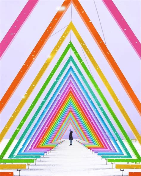 A Person Standing In Front Of A Very Colorful Structure