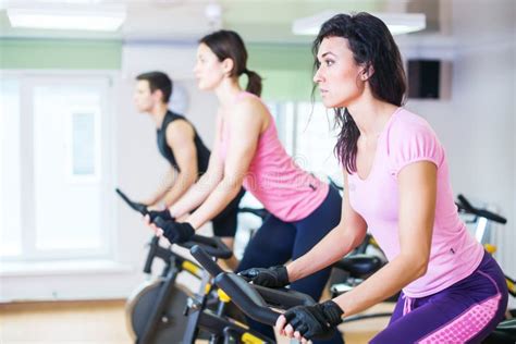 Group Training People Biking In The Gym Exercising Legs Doing Cardio Workout Cycling Bikes