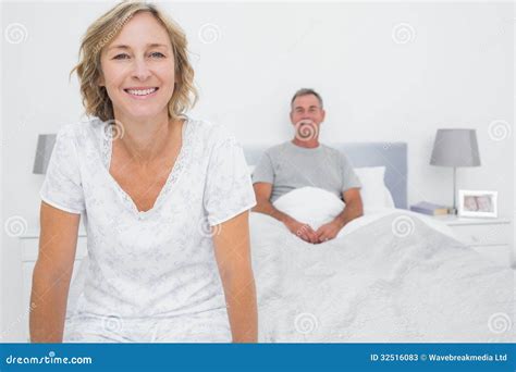 Happy Couple Sitting On Opposite Ends Of Bed Stock Image Image Of