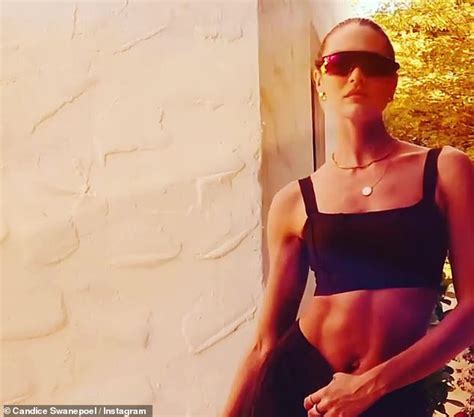 Candice Swanepoel Shows Off Her Toned Abs In An Alo Brown Sports Bra