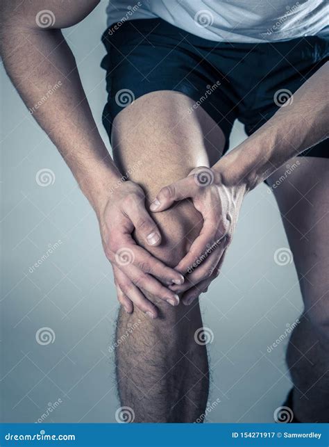 Sport Man Injured When Exercising Or Running Holding His Knee In Pain