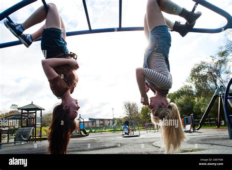 Two 16 17 Year Old Teenage Girls Hanging Upside Down In A Playground