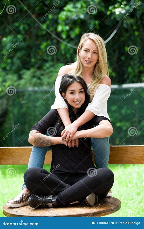 A Pair Of Proud Lesbian In Outdoors Sitting On A Wooden Table Blonde