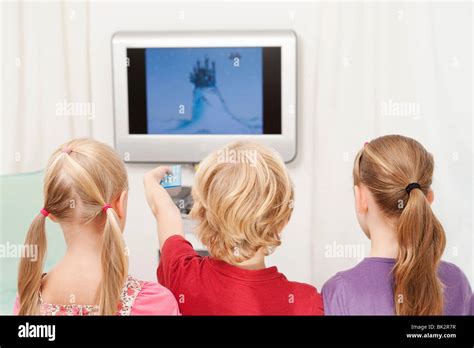 Three Children Watching Television Stock Photo Alamy