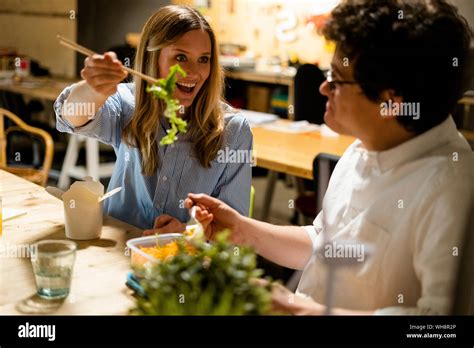 Colleagues In Office Having Lunch Break Sharing Salad Stock Photo Alamy