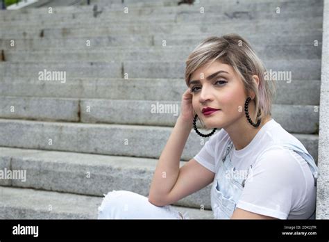 Portrait Of Beautiful Young Woman Sitting On Staircase Stock Photo Alamy