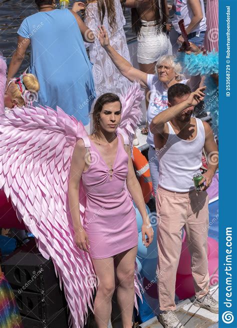 people on the pride amsterdam trans commission boat at the gaypride canal parade with boats at