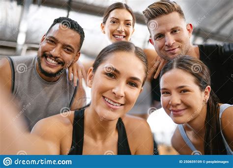 Portrait Of A Diverse Group Of Happy Sporty People Taking Selfies While Exercising Together In A