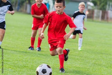 Boy Kicking Soccer Ball Stock Photo Adobe Stock