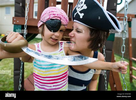 Mother And Daughter In Pirates Costumes Playing At Playground Stock