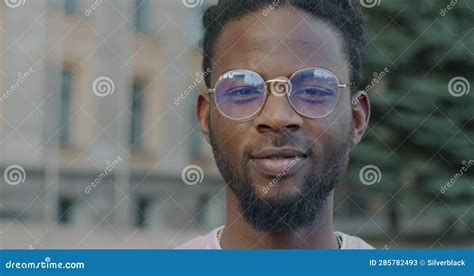 Close Up Portrait Of Good Looking African American Man Smiling Looking At Camera Outside In Town