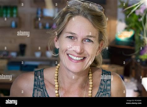 portrait of french blonde mature woman smiling in her handmade ts store in france