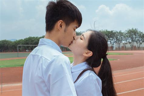 Young Asian College Couple Kissing By Stocksy Contributor Pansfun Images Stocksy