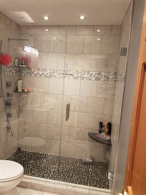 Houston tile works is your local tile installation contractor. Tile Shower featuring a river rock floor with a marble ...