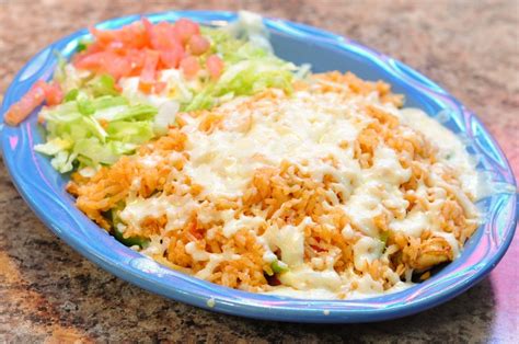 The chicken and rice are simmered with onions, peppers and tomatoes until the meat is infused with flavor. authentic mexican arroz con pollo