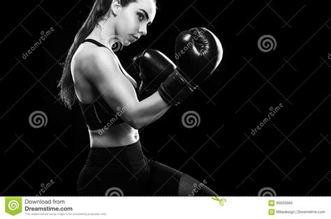 Woman Boxer Fighting In Boxing Cage Isolated On Black