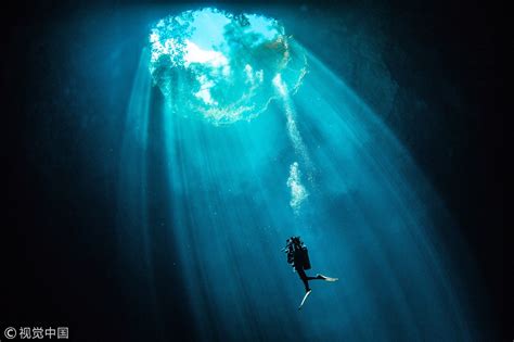 When A Column Of Sunlight Shone Through The Clear Water In An Underwater Cave In Cancun Mexico