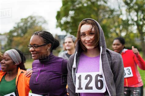 Portrait Smiling Female Runner At Charity Run In Park Stock Photo