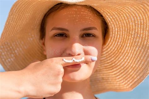 Cute Woman Is Posing With Moustache Drawn With Sun Cream On Her Finger