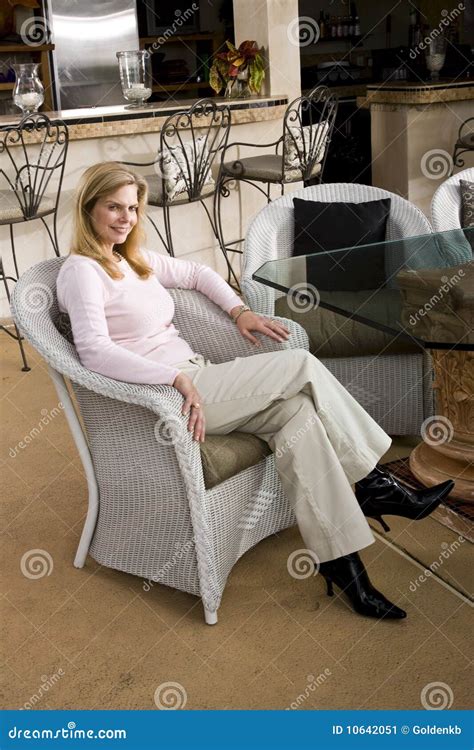Mature Woman Relaxing On Wicker Chair Stock Image Image Of Table Toothy 10642051