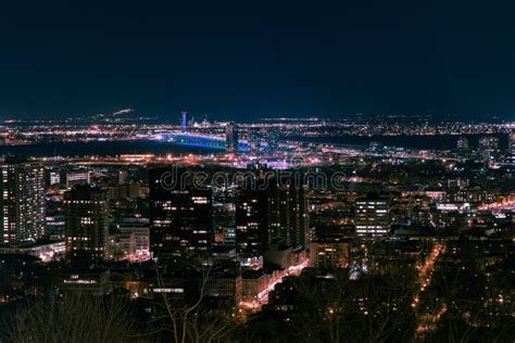 Cityscape Of Montreal Surrounded By Buildings And Lights In The Night
