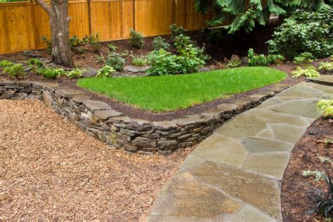 Rosetta hardscapes outcropping retaining walls provide homeowners the large, natural rock landscaping look they want in a structurally sound solution they need. dry stacked stone wall softscape slight slope pathway ...