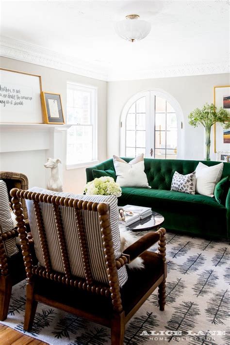 But two strong colours can live in hue harmony; Gorgeous living room with green Sofa and to ticking ...