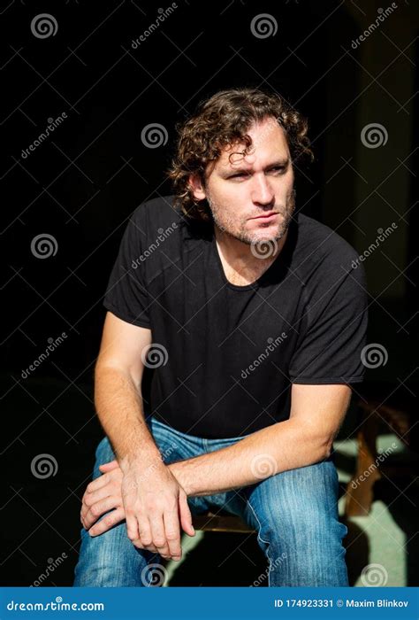 Portrait Of Brooding Man Sitting On Chair Stock Image Image Of