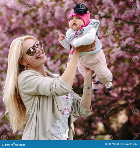 Beautiful Young Mother Walks With A Small Daughter Stock Image Image Of Happiness Flower