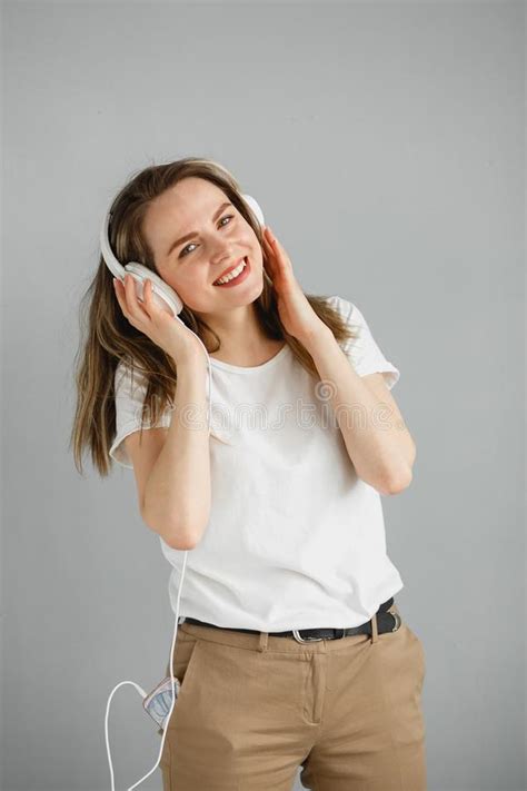 Enjoy The Music Happy Young Woman Pleasing Music In White Headphones