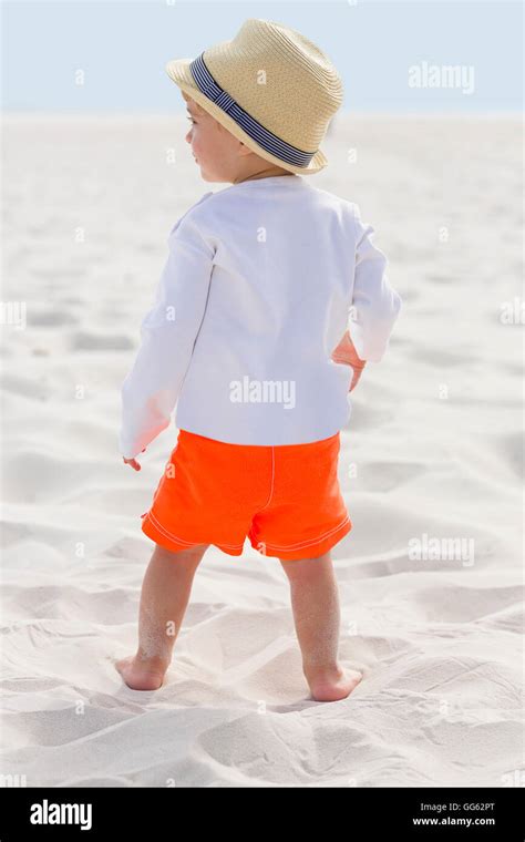 Rear View Of A Baby Boy Standing On The Beach Stock Photo Alamy