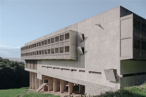 The Building Is Made Out Of Concrete And Has Multiple Balconies