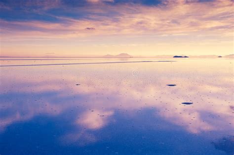 Mirror Surface Of Salar De Uyuni Salt Flat At Sunset In Bolivia Stock