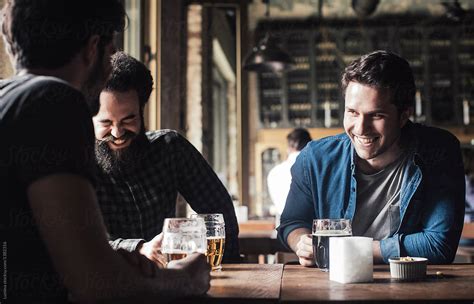 Friends Drinking Beer At Pub By Stocksy Contributor Lumina Stocksy
