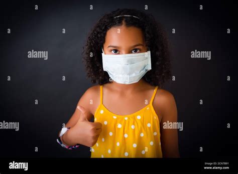 African American Girl With Face Mask Doing Thumbs Up Stock Photo Alamy