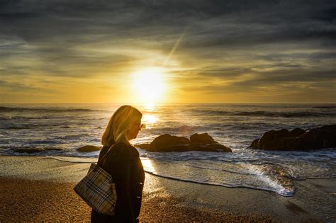 Woman Walking On The Beach During Sunset Image Free Stock Photo