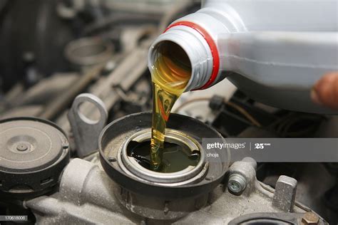 In Auto Repair Shopcar Mechanic Is Changing Engine Oil