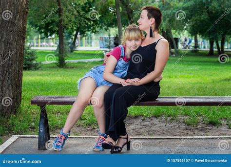 Mother And Daughter Sitting On A Bench In The Park Stock Image Image