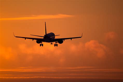 Plane Landing At Sunset