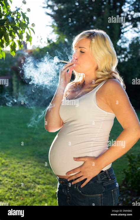 Pregnant Woman Smoking A Cigarette Stock Photo Alamy