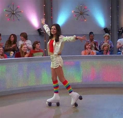 A Woman Is Roller Skating In Front Of A Crowd