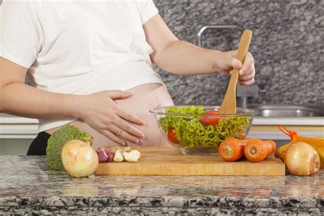 Asian Pregnancy Woman Cooking Salad In The Kitchen Ironmommycl