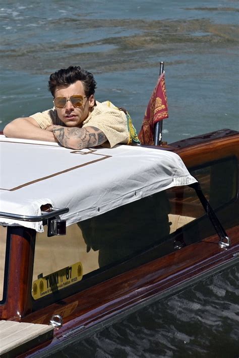 harry styles on a speedboat really is the most diverting distraction british vogue