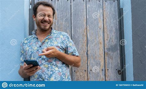 Guy Watching A Video In Social Media And Laughing With Gesturing Of