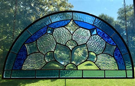 A Large Stained Glass Window In The Shape Of A Flower With Blue And