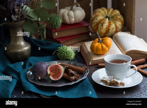 Autumnal Still Life With Figs Cinnamon Sticks Books And A Cup Of Tea